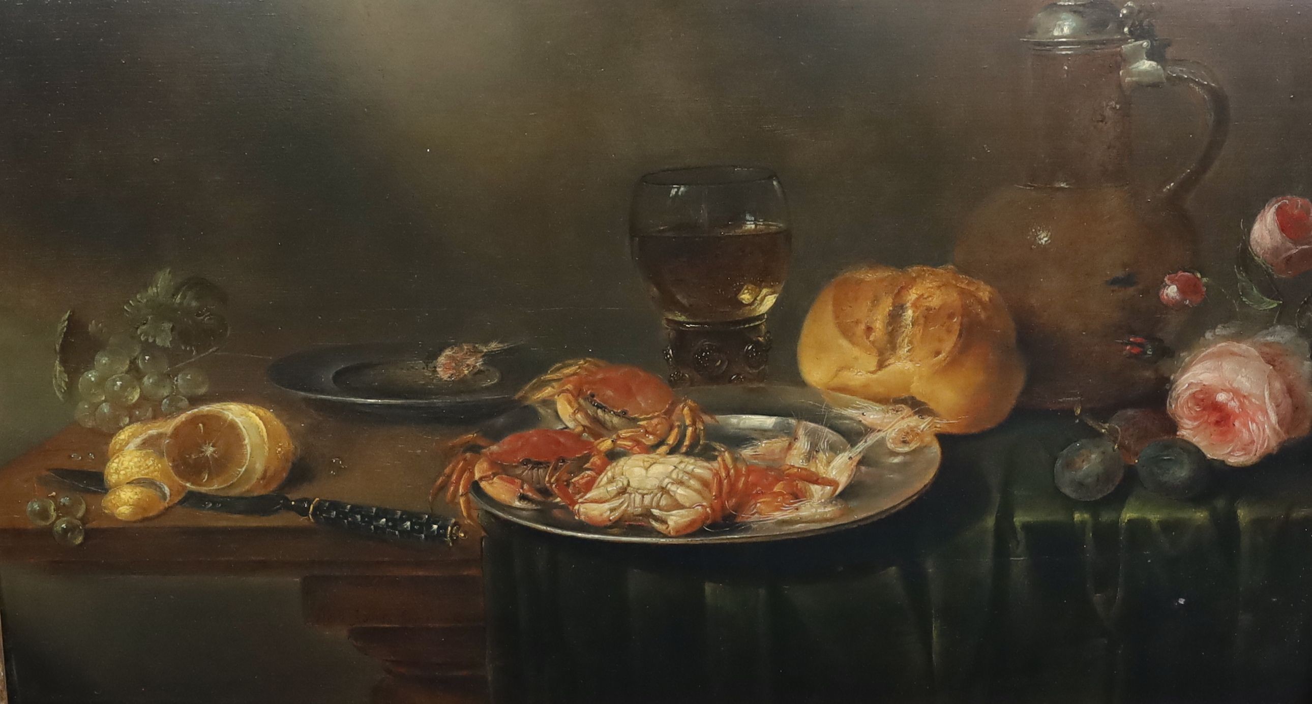 Alexandre Adriaensen (1587-1661), Still life of crabs, fruit, a loaf of bread, rummer, flagon and flowers upon a table top, oil on wooden panel, 40 x 70cm.